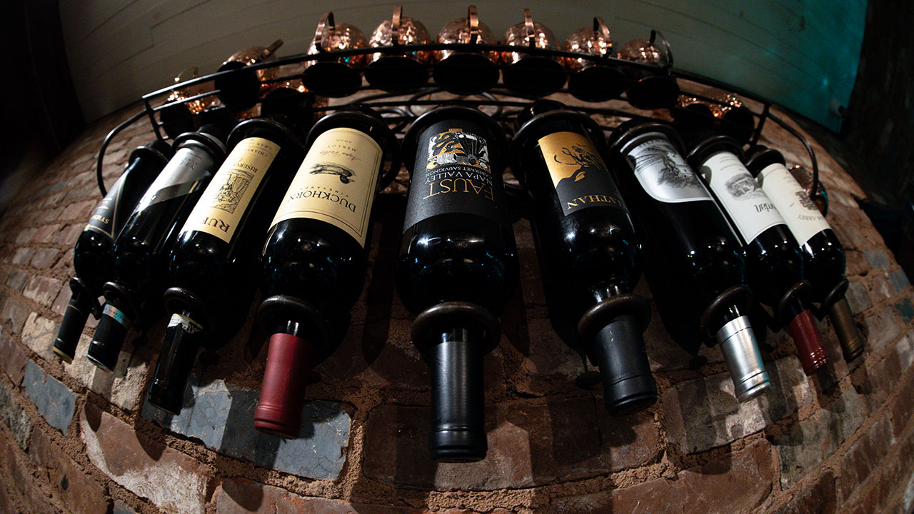 photo of fine wines laid on their side on a wine barrel at Tam's Backstage Restaurant in Cumming Georgia